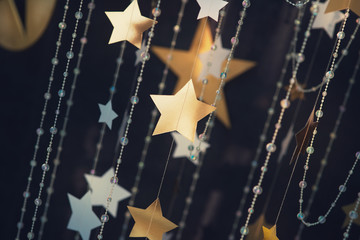 Gold star in sun light with stars background