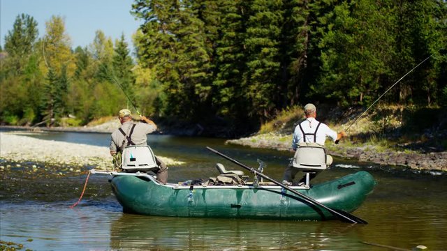 Males fly fishing from rib boat freshwater River Canada BC