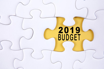 Fototapeta premium Business concept: 2019 BUDGET word on a jigsaw puzzle background.