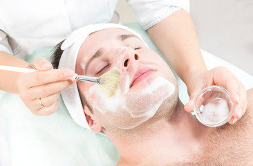 Man in the mask cosmetic procedure in spa salon 