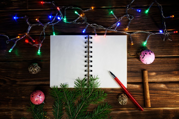 Template letters with New Year and Christmas greetings or a list of gifts. Opened notebook is located horizontally