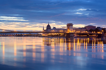 Night view of Chain bridge and illuminated Budapest downtown reflecting in the river