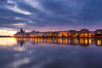 Night view of illuminated Budapest riverfront reflecting in the river