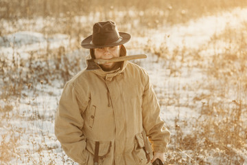 Obraz premium Lumberjack man on winter day, snowy steppe. Handsome male, hipster. Ax in the teeth