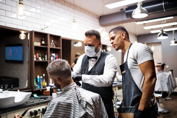 Hipster man client visiting haidresser and hairstylist in barber shop, training concept.