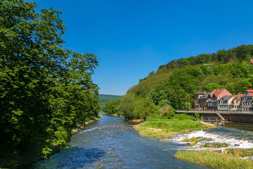 Fototapeta na wymiar Beautiful landscape view of the river Werra flowing through Hann. Münden, a town in Lower Saxony, Germany on a nice sunny day with a blue sky. 