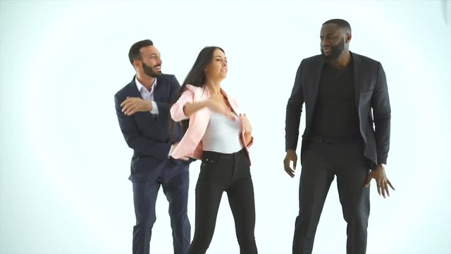 The three happy people dancing on the white background