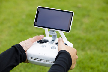 Drone remote control ,Remote control of the drones in hand,Green grass background