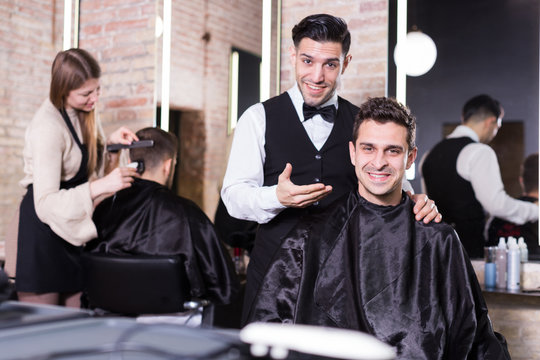 Male discussing haircut with hairdresser