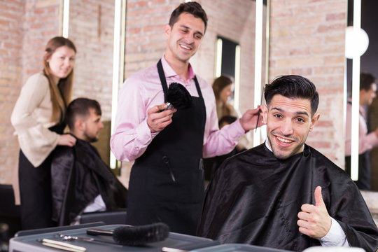 Satisfied male client of barbershop