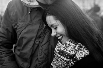 Beautiful woman with red lips is smiling in her boyfriend arms