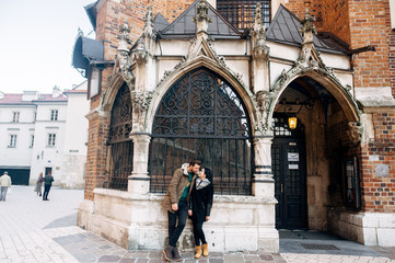 Fototapeta na wymiar Happy couple are hugging on the old town