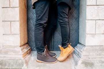 feet of a guy and a girl in brown shoes