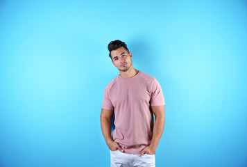 Young man in t-shirt on color background. Mockup for design