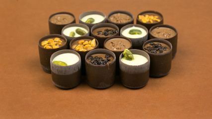 Chocolate candy laid out on a brown background. Luxury expensive candy laid out on a dark brown background.