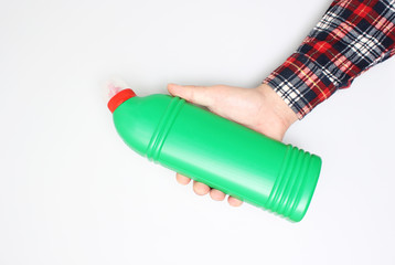 bottle of green toilet in hand