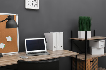 Stylish workplace with modern laptop in home office