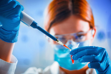 Biotechnology. Female scientist working in laboratory - obrazy, fototapety, plakaty