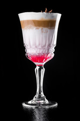 Hot Coffee layered Cocktail isolated on black in a beautiful glass, sweet pink syrup. close up. series of photos. dark background