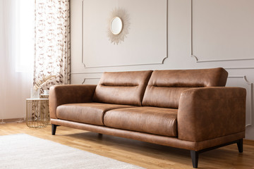 Real photo of a leather couch in a living room interior - obrazy, fototapety, plakaty