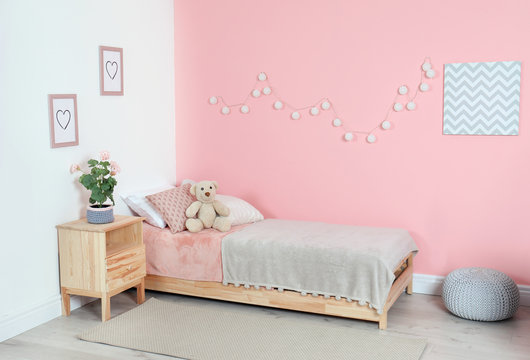 Cozy child's room interior with comfortable bed