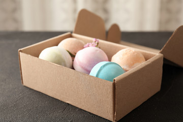 Carton box with bath bombs on black table
