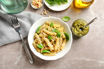 Plate of delicious basil pesto pasta served for dinner on table, flat lay © New Africa