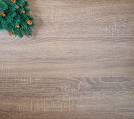 Christmas tree on brown wooden texture background.