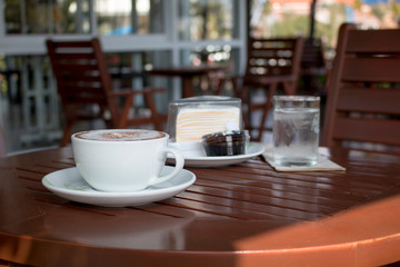 Closeup of A cup of Latte Art hot coffee over wooden  table