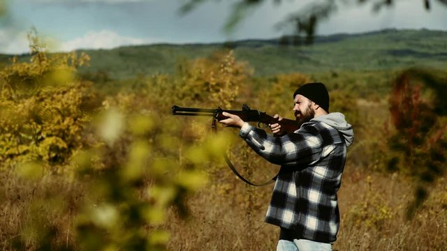 Hunting season. Man with gun. Hunting Licenses. Poacher with Rifle Spotting Some Deers. Illegal Hunting Poacher in the Forest.