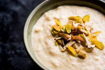 Sweet Rabdi or Lachha Rabri or basundi, made with pure milk garnished with dry fruits. Served in a bowl over moody background. Selective focus