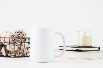 styled white mug mockup with a candle and books