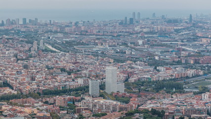 Barcelona and Badalona skyline with roofs of houses and sea on the horizon at evening timelapse