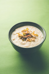 Sweet Rabdi or Lachha Rabri or basundi, made with pure milk garnished with dry fruits. Served in a bowl over moody background. Selective focus