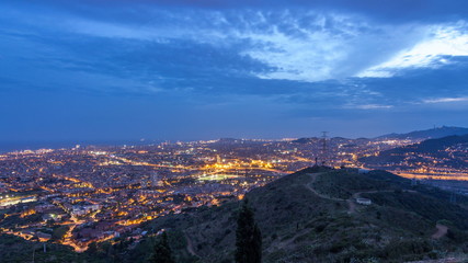 Barcelona and Badalona skyline with roofs of houses and sea on the horizon day to night timelapse