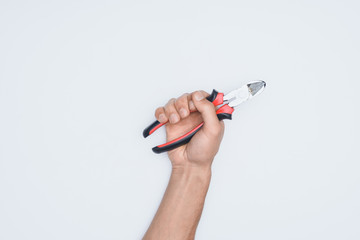 cropped shot of man holding pliers isolated on white