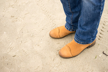 Fototapeta na wymiar Man on beach wearing suede shoes