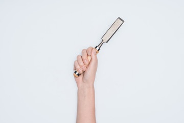 cropped shot of woman holding chisel isolated on white