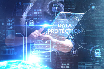 The concept of business, technology, the Internet and the network. A young entrepreneur working on a virtual screen of the future and sees the inscription: Data protection
