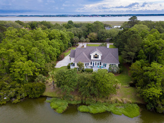 Fototapeta na wymiar Aerial view of waterfront home on wooded property