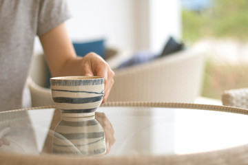A Business woman is holding a white coffee cup