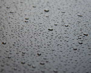 Raindrops on the car's matte surface