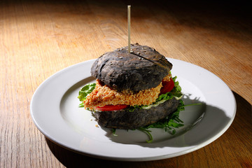 Black burger with grilled chicken 