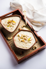 Sweet Rabdi or Lachha Rabri or basundi, made with pure milk garnished with dry fruits. Served in a bowl over moody background. Selective focus