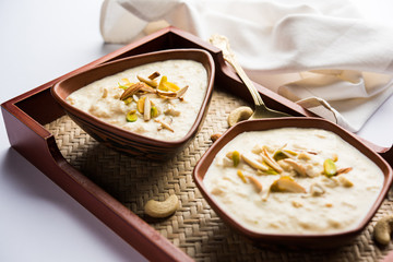 Sweet Rabdi or Lachha Rabri or basundi, made with pure milk garnished with dry fruits. Served in a bowl over moody background. Selective focus