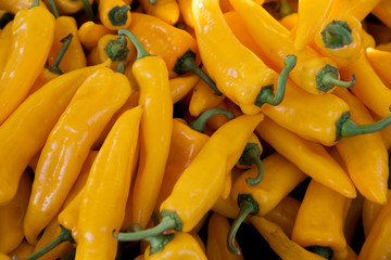 Chilli closeup, yellow pods on the counter market. Chile pepper, Cayenne pepper, Pungent bouquet of pepper, Chinese pepper. Great photo for the sellers of vegetables. - 233404952