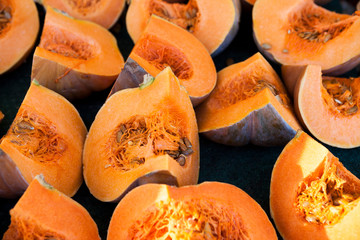 Large tasty slices of pumpkin with seeds. Pumpkin slices.