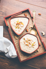 Sweet Rabdi or Lachha Rabri or basundi, made with pure milk garnished with dry fruits. Served in a bowl over moody background. Selective focus
