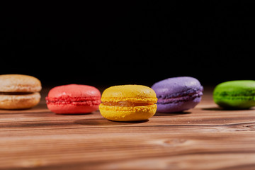 Cake macaron or macaroon on black background from, colorful almond cookies