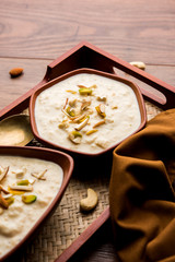 Sweet Rabdi or Lachha Rabri or basundi, made with pure milk garnished with dry fruits. Served in a bowl over moody background. Selective focus